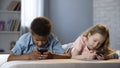 Boy and girl surfing internet smartphones, lack of communication, entertainment