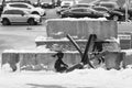 A boy and a girl swing on an anti-tank hedgehog - Banksy graffiti in Kyiv, Ukraine, black and white photo