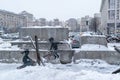 A boy and a girl swing on an anti-tank hedgehog - Banksy graffiti in Kyiv, Ukraine