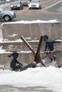 A boy and a girl swing on an anti-tank hedgehog - Banksy graffiti in Kyiv, Ukraine