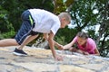 Boy and girl play on mountain. children tourists travelers climb mountain. Royalty Free Stock Photo