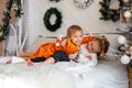 A boy and a girl in tiger cubs costumes play on the bed.Children in kigurumi pajamas Royalty Free Stock Photo