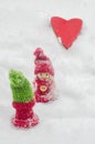 Boy and girl toy figurines in winter, big red heart, love.