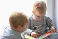 Boy and girl twins reading book