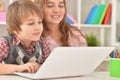Boy and girl using laptop together at home Royalty Free Stock Photo