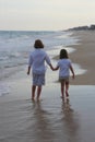 Boy and girl walking on the beach Royalty Free Stock Photo