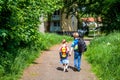Boy and girl walking holding hands and carrying backpacks Royalty Free Stock Photo