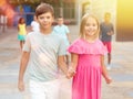 Boy and girl walking together hand in hand