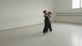 Little boy and girl waltzing in a dancing hall