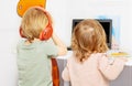 Boy and a girl watch education videos over internet on laptop Royalty Free Stock Photo