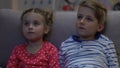 Boy and girl watching tv at night, scared when parents suddenly return home