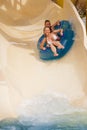 Boy and girl on water slide Royalty Free Stock Photo