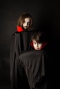 A boy and a girl wearing as vampires for halloween