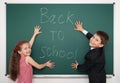 Boy and girl write back to school on board Royalty Free Stock Photo