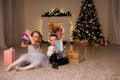 Boy and girls open Christmas presents new year Christmas tree Royalty Free Stock Photo