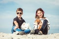 Happy 11 year old boy hugging his dog breed Samoyed at the seashore against a blue sky close up. Best friends rest and Royalty Free Stock Photo