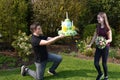 Boy gives flowers  and birthday gift to his girlfriend Royalty Free Stock Photo