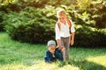 Boy gives hand to his little brother on a walk. School boy helps to stand up his friend. Children help and support each other Royalty Free Stock Photo