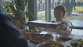 Boy gives a present to his father in a cafe Royalty Free Stock Photo