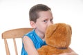 Boy giving bear friend a kiss Royalty Free Stock Photo