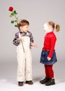 Boy giving preschool girl rose Royalty Free Stock Photo