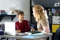 Boy gladly doing his homework with his mother