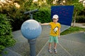 Boy with globe at observatory park in planetarium. Ready to fly