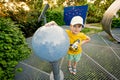 Boy with globe at observatory park in planetarium. Ready to fly