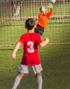 Boy goalkeeper defends