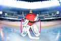 Boy goaltender under the lights of hockey stadium