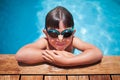Boy with goggle in the swimming pool looking at camera Royalty Free Stock Photo