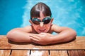 Boy with goggle in the swimming pool looking at camera Royalty Free Stock Photo