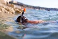 Boy in goggles and pipe diving in sea at summer Royalty Free Stock Photo