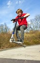 Boy going airborne with a scooter