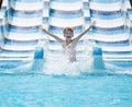 Boy going down water slide in pool Royalty Free Stock Photo