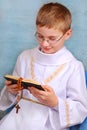 Boy going to the first holy communion with prayer book Royalty Free Stock Photo