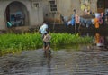 A boy going to school n the flooded area of Iba Lagos Nigeria 2016