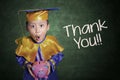 Boy with graduation gown holding piggybank Royalty Free Stock Photo