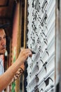 Boy graffiti, painted with marker pen, on the blind of a store