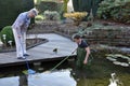 Boy and grandmother cleaning garden pond Royalty Free Stock Photo