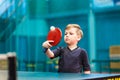 Boy in gray t-shirt playing table tennis Royalty Free Stock Photo