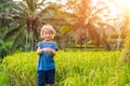 Boy on Green cascade rice field plantation at Tegalalang terrace. Bali, Indonesia Traveling with children concept Royalty Free Stock Photo