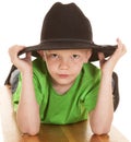 Boy green shirt cowboy hat look serious lay Royalty Free Stock Photo