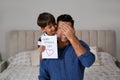 Little boy greeting his dad with Father`s Day at home Royalty Free Stock Photo