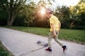 Boy in grey helmet riding skateboard on road in park on summer day. Seasonal outdoors children activity sport. Healthy childhood Royalty Free Stock Photo