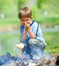 Boy grilling sausages Royalty Free Stock Photo