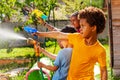 Boy with group of children shoot water pistol Royalty Free Stock Photo