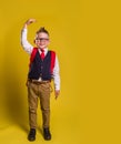 Boy growing tall and measuring himself on the wall. Back to school. Pupil in uniform.