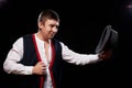 Boy or guy in national ethnic clothing posing in Studio on black background. Young man with hat in dark room Royalty Free Stock Photo