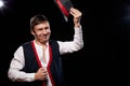 Boy or guy in national ethnic clothing posing in Studio on black background. Young man with hat in dark room Royalty Free Stock Photo